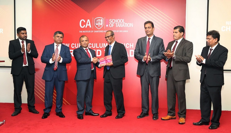 Mr. Sanjaya Bandara presenting the first copy of the revamped curriculum of the Chartered Tax Advisor to Mr. Hapuarachchi.