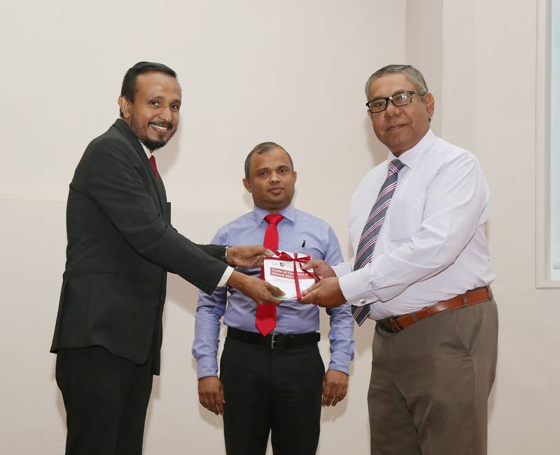 Prof. Roshan Ajward, Chairman of the Education & Curriculum Development Committee presenting the first copy of the code to Mr. Reyaz Mihular in the presence of Mr. Sanjaya Bandara, President of CA Sri Lanka.